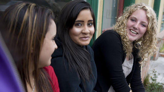 three young women in conversation